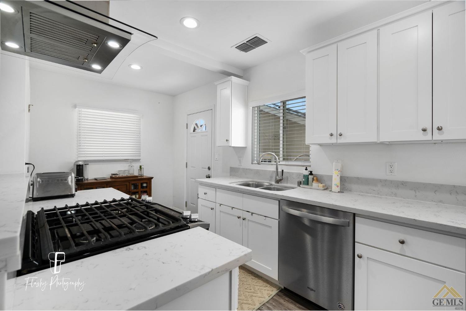 Undisclosed Address Bakersfield, CA 93305 - Photo 14 of 20 a kitchen with a sink stove and cabinets