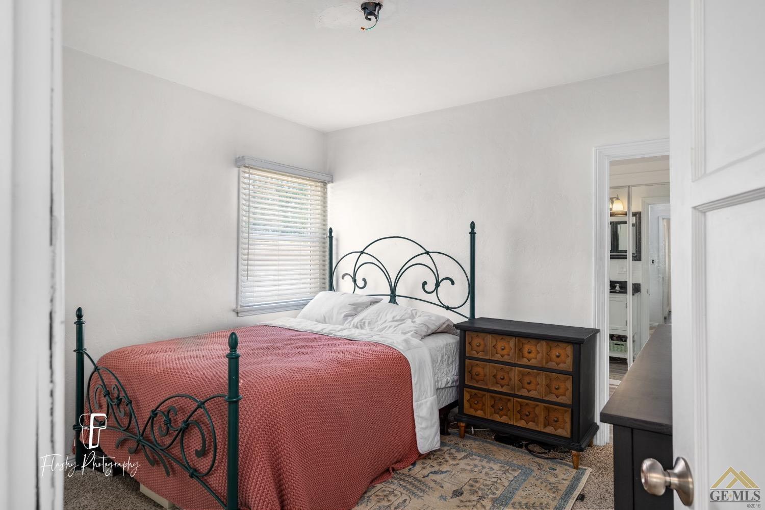 Undisclosed Address Bakersfield, CA 93305 - Photo 15 of 20 a bedroom with a bed a dresser with the shoe rack