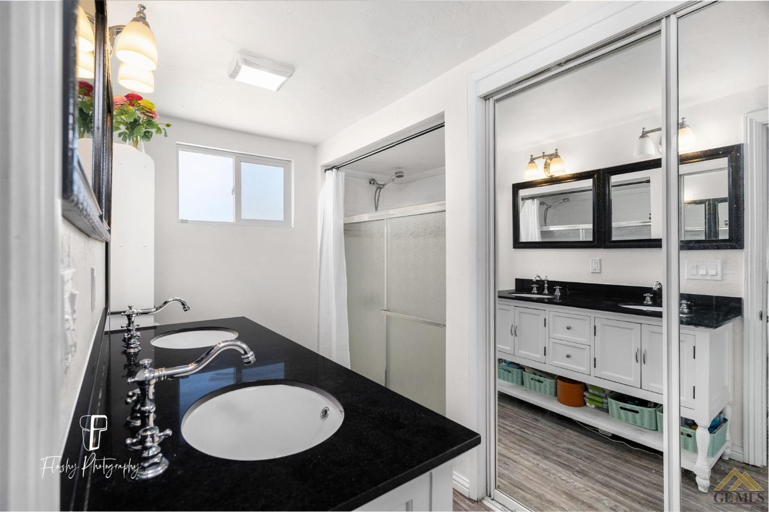 Undisclosed Address Bakersfield, CA 93305 - Photo 17 of 20 a bathroom with a sink and a mirror