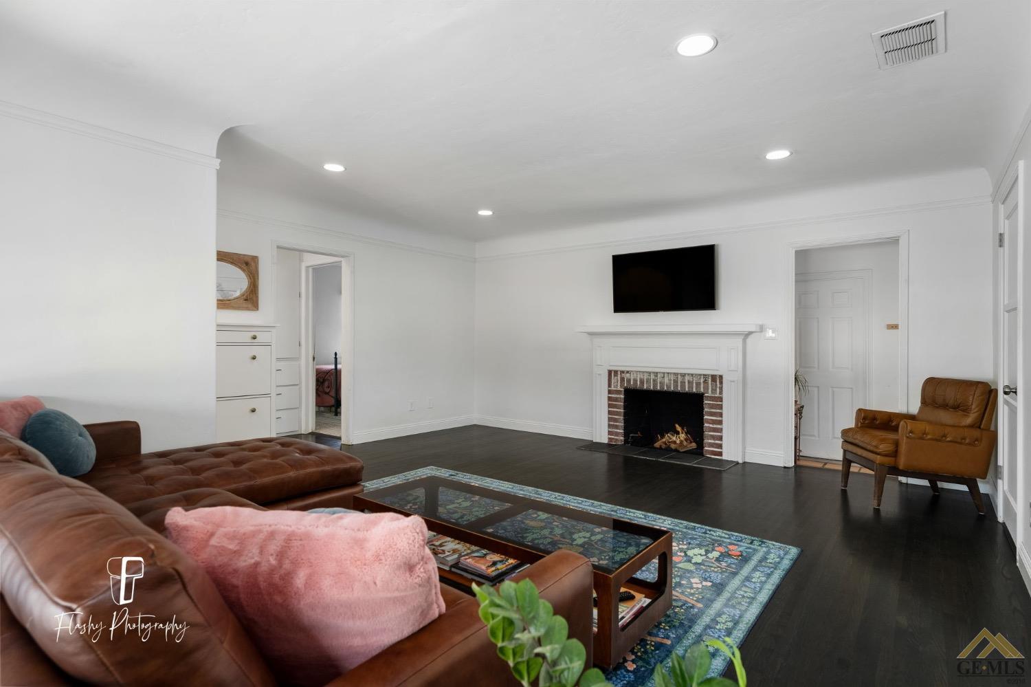 Undisclosed Address Bakersfield, CA 93305 - Photo 10 of 20 a living room with furniture and a fireplace