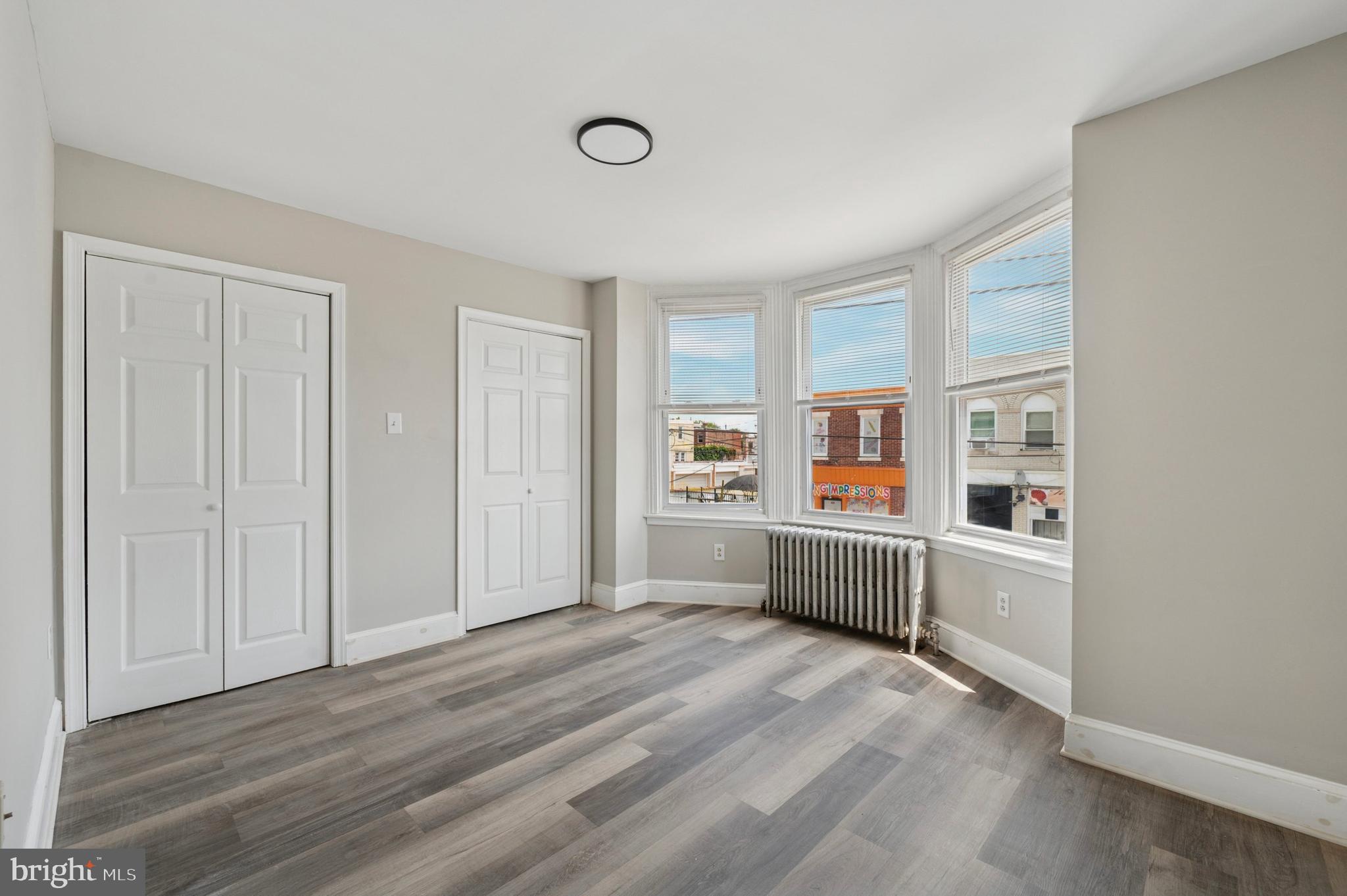 424 North 64th Street Philadelphia, PA 19151 - Photo 17 of 35 an empty room with wooden floor cabinet and windows