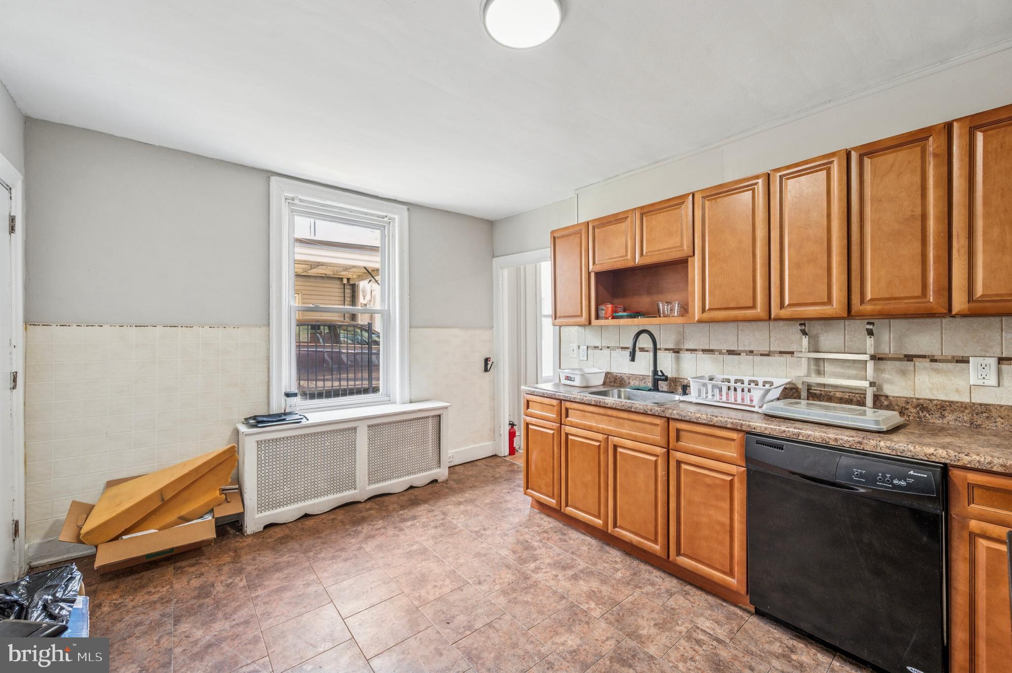 424 North 64th Street Philadelphia, PA 19151 - Photo 31 of 35 a kitchen with granite countertop a sink stove and cabinets