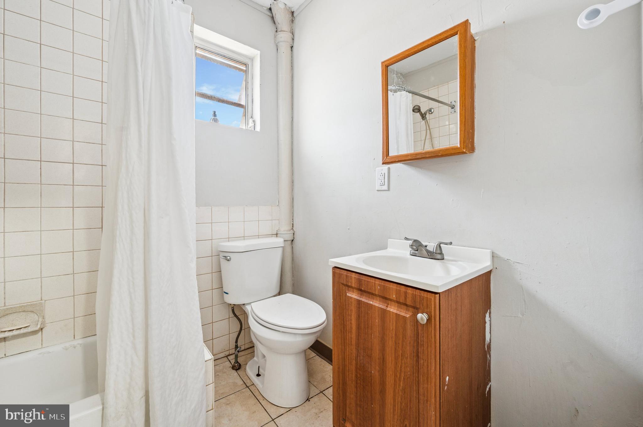 424 North 64th Street Philadelphia, PA 19151 - Photo 35 of 35 a bathroom with a toilet a sink and mirror