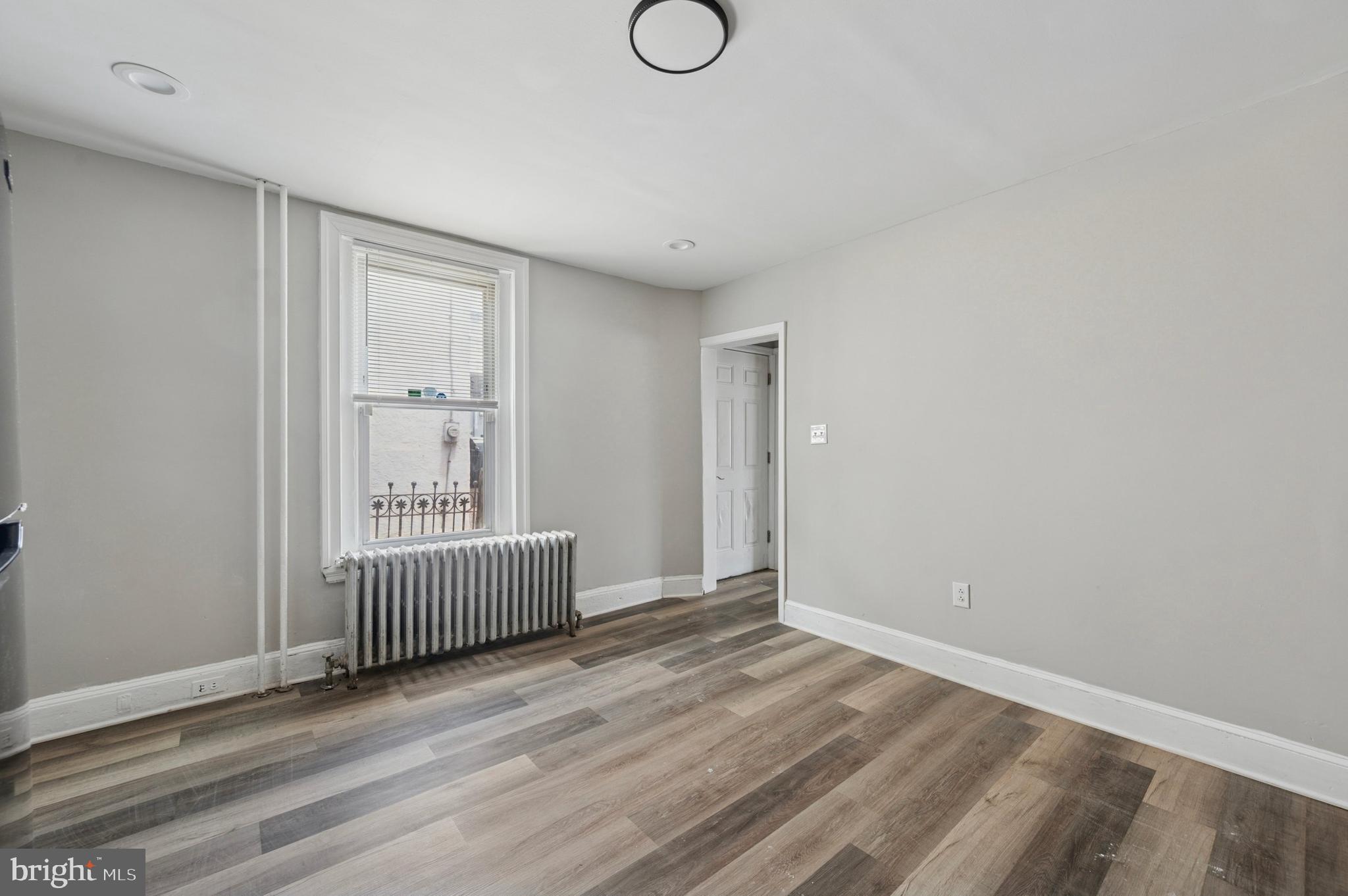 424 North 64th Street Philadelphia, PA 19151 - Photo 6 of 35 a view of room with window and wooden floor