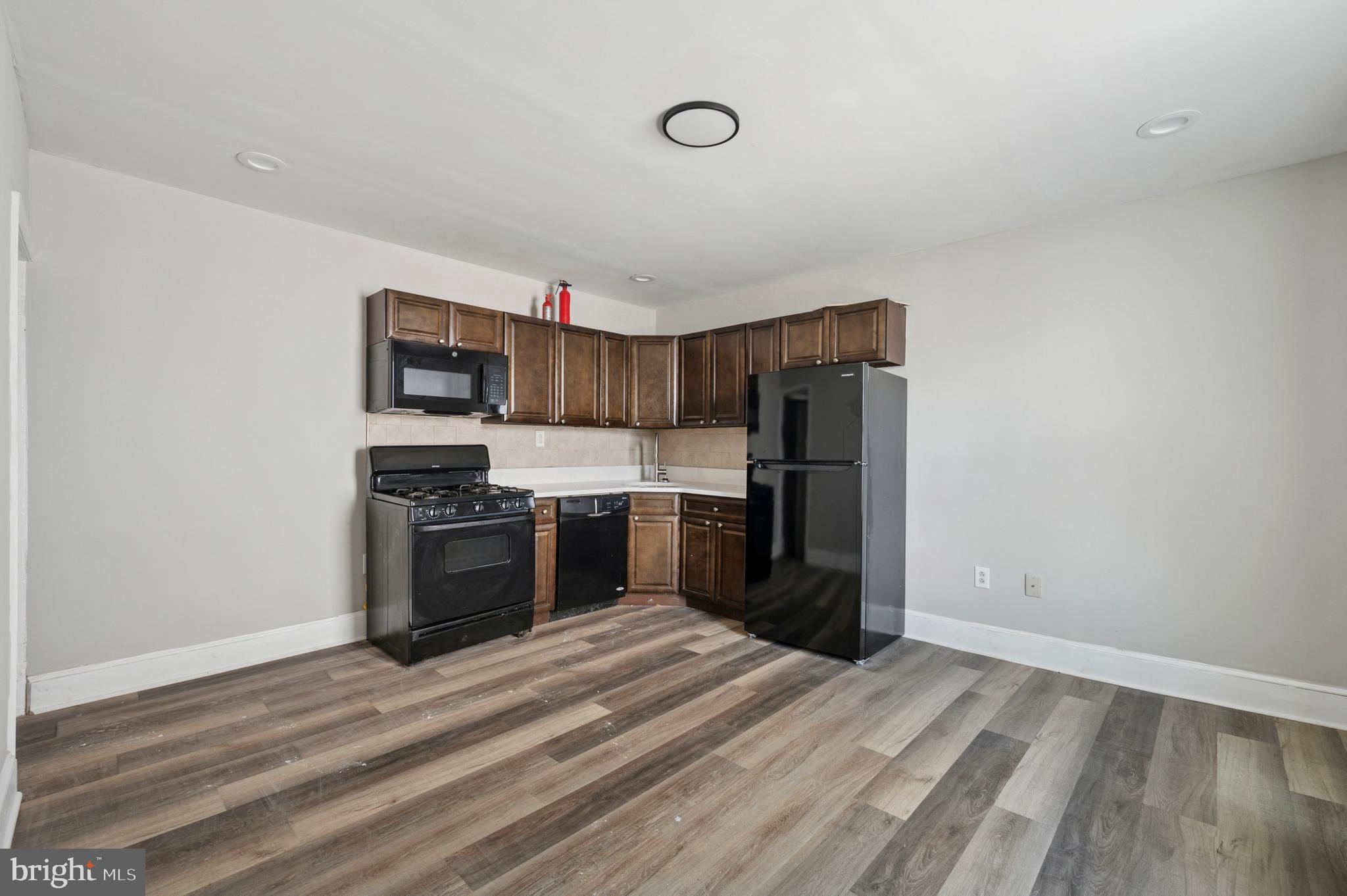 424 North 64th Street Philadelphia, PA 19151 - Photo 7 of 35 a kitchen with stainless steel appliances a refrigerator and a stove top oven