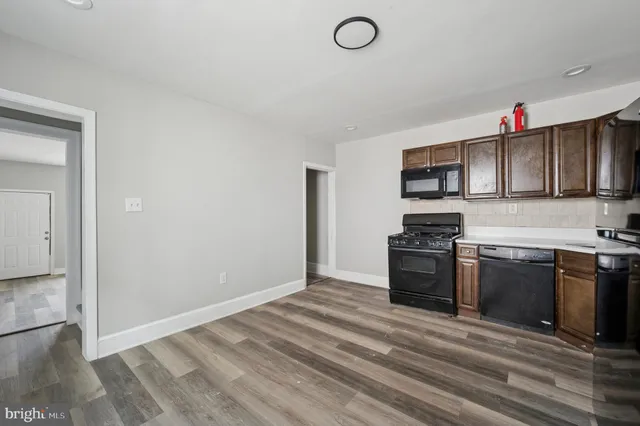 a kitchen with a stove top oven and sink