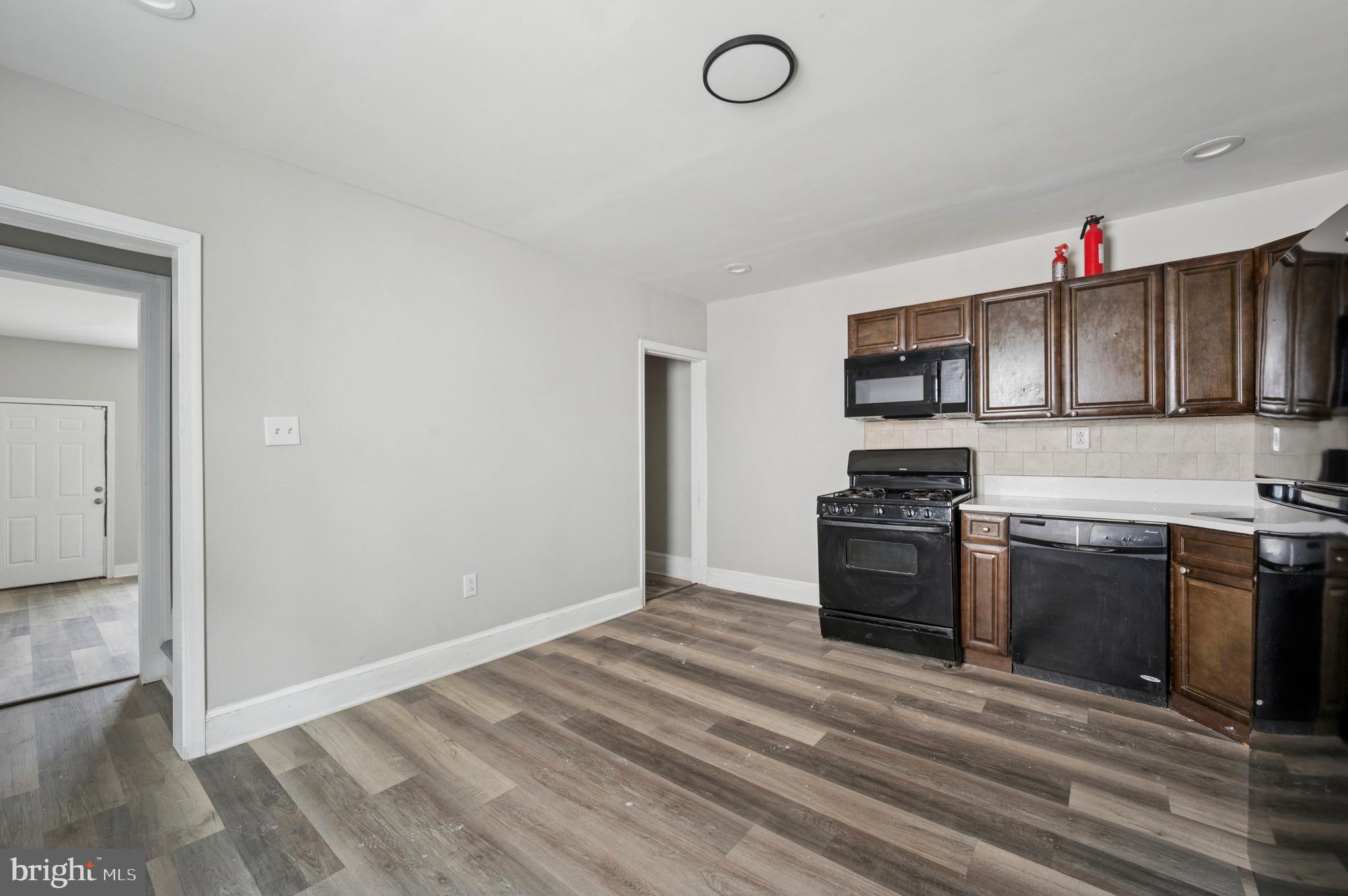 424 North 64th Street Philadelphia, PA 19151 - Photo 8 of 35 a kitchen with stainless steel appliances granite countertop a stove a sink and a refrigerator