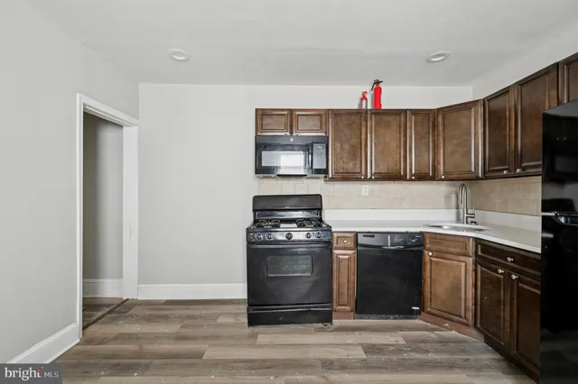 a kitchen with refrigerator cabinets and wooden floor