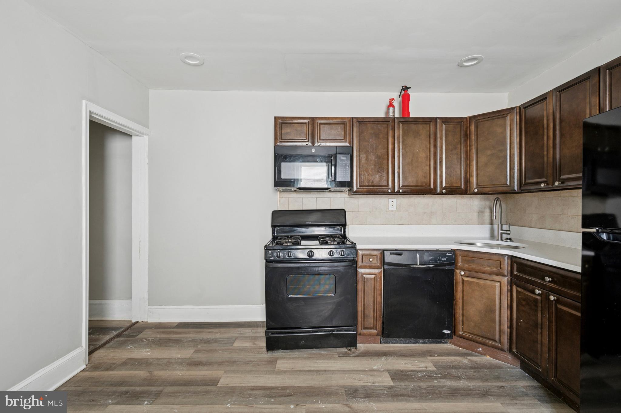 424 North 64th Street Philadelphia, PA 19151 - Photo 9 of 35 a kitchen with a stove top oven and sink