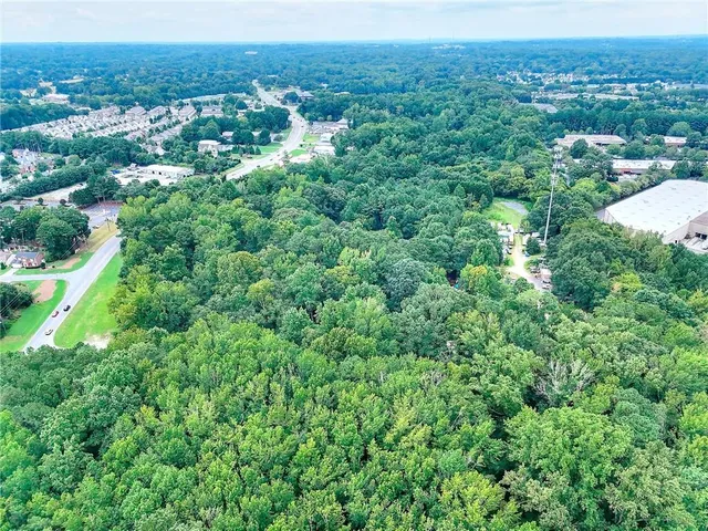 a view of a garden with a building in the background