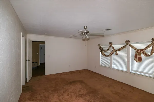 a view of a room with a ceiling fan