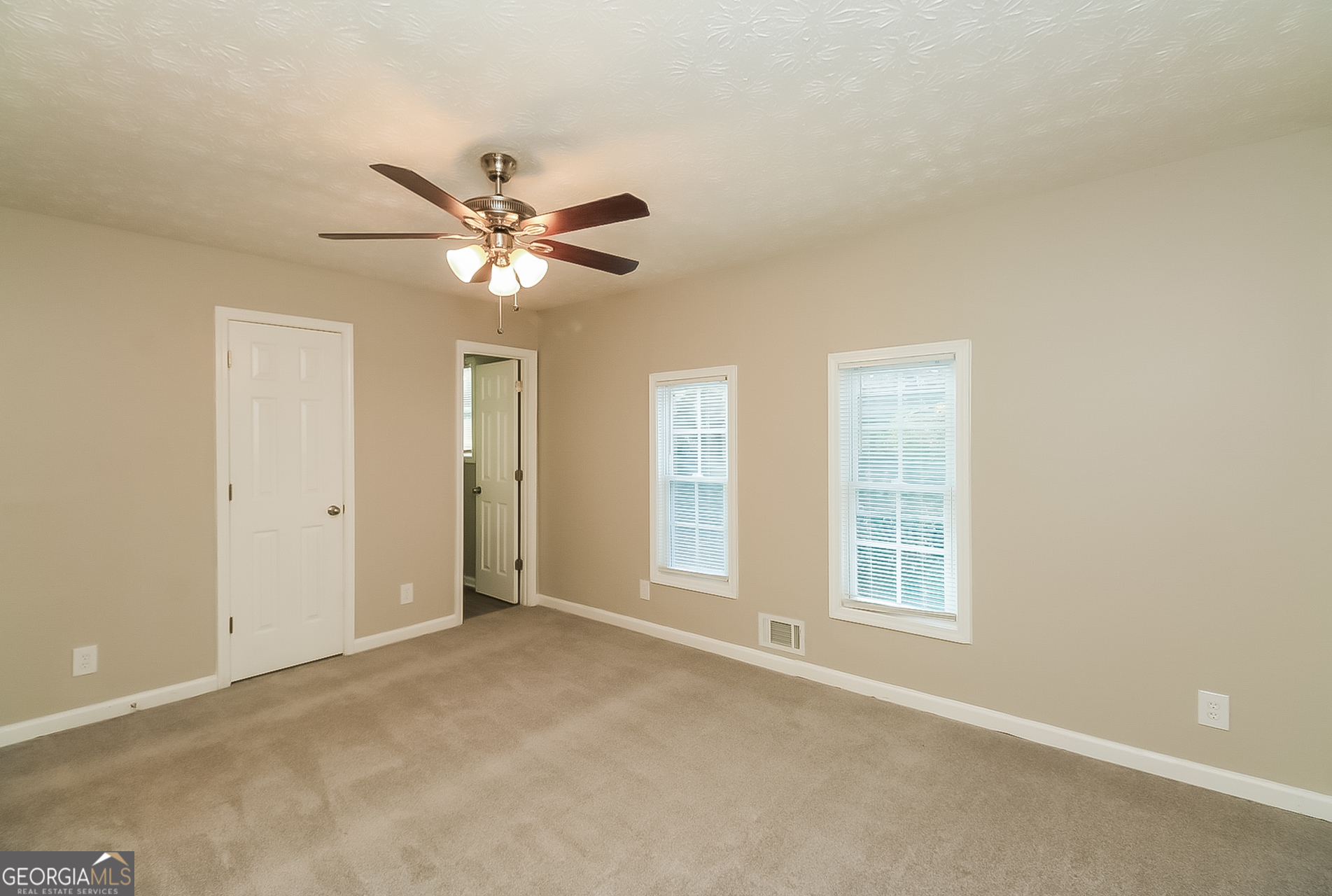 2875 Kathryn Circle Southwest Atlanta, GA 30331 - Photo 7 of 18 a view of an empty room with a ceiling fan and a window