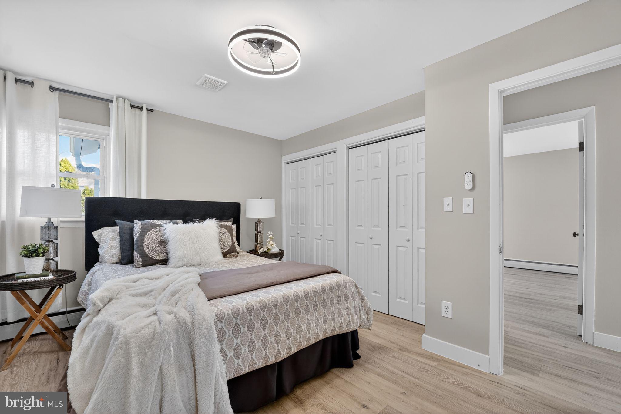 9337 Millbrook Road Ellicott City, MD 21042 - Photo 11 of 33 a bedroom with a bed and a chandelier