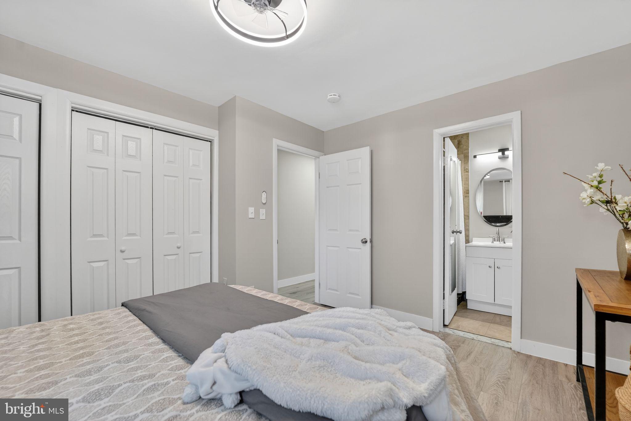 9337 Millbrook Road Ellicott City, MD 21042 - Photo 13 of 33 a bedroom with a bed and hallway