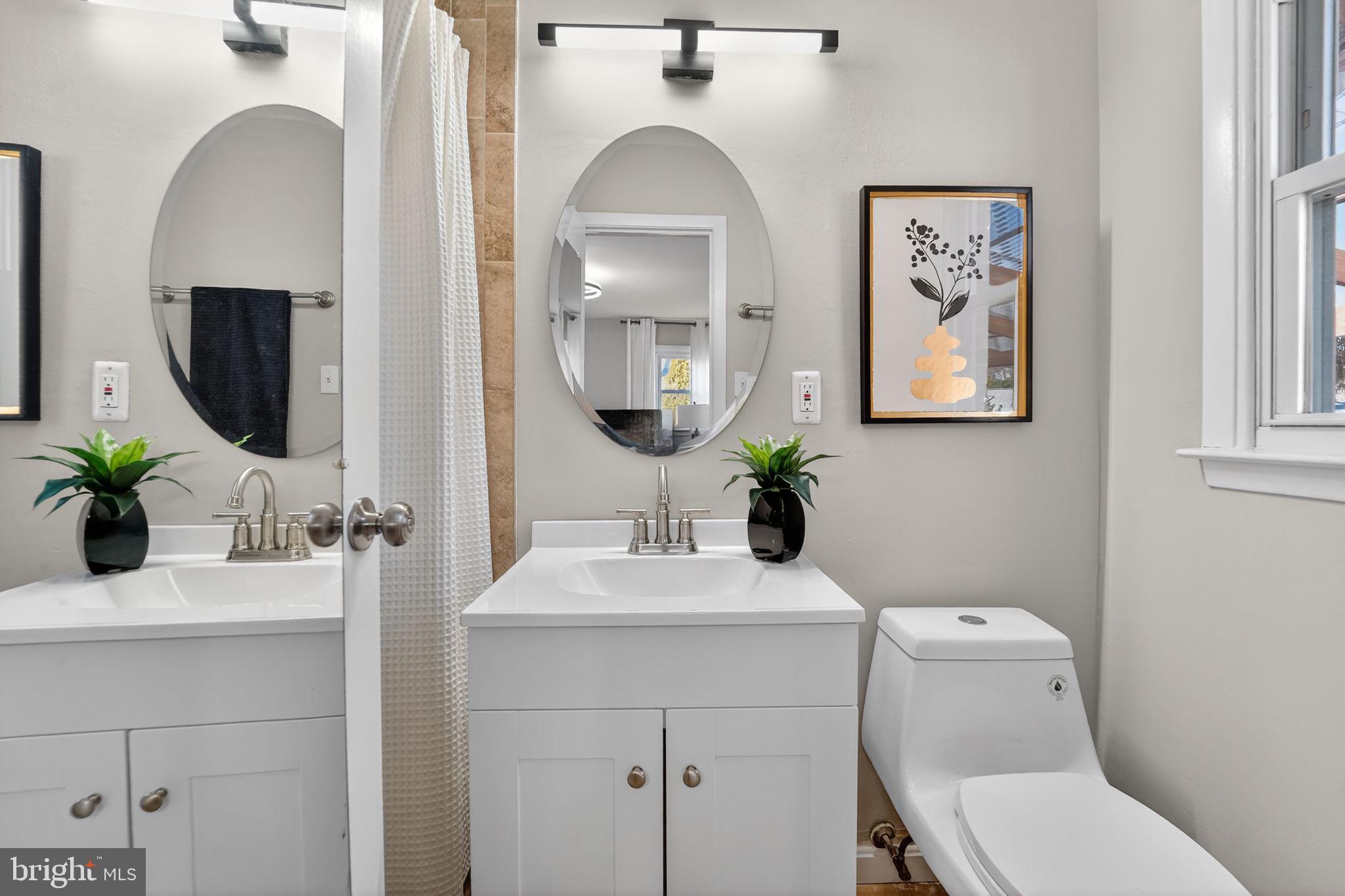 9337 Millbrook Road Ellicott City, MD 21042 - Photo 14 of 33 a bathroom with a toilet sink and mirror