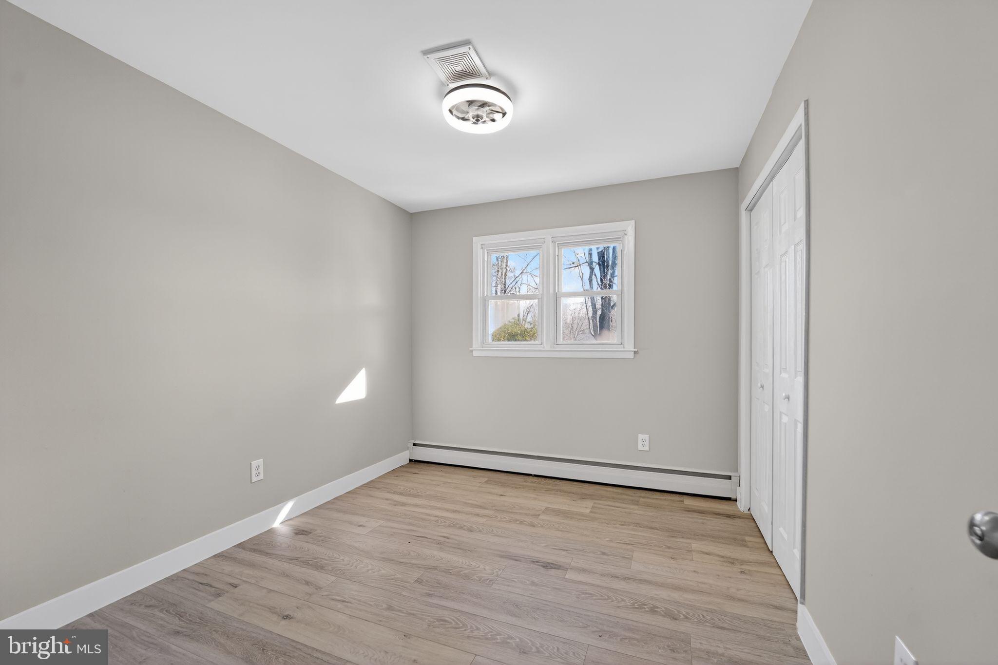9337 Millbrook Road Ellicott City, MD 21042 - Photo 16 of 33 wooden floor in an empty room