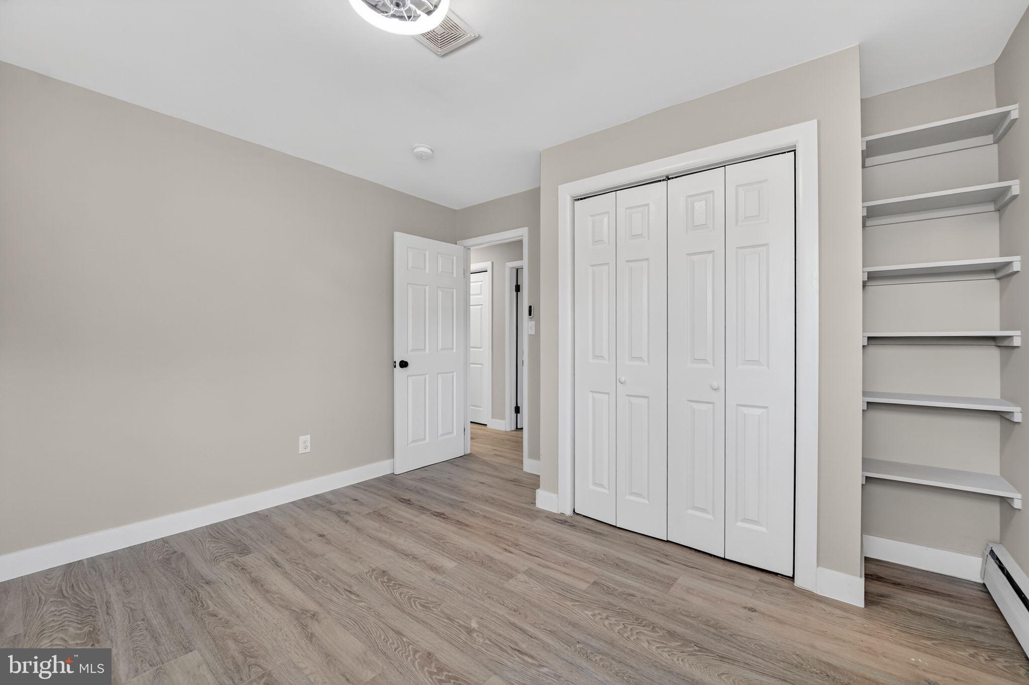 9337 Millbrook Road Ellicott City, MD 21042 - Photo 17 of 33 a view of an empty room with wooden floor and closet