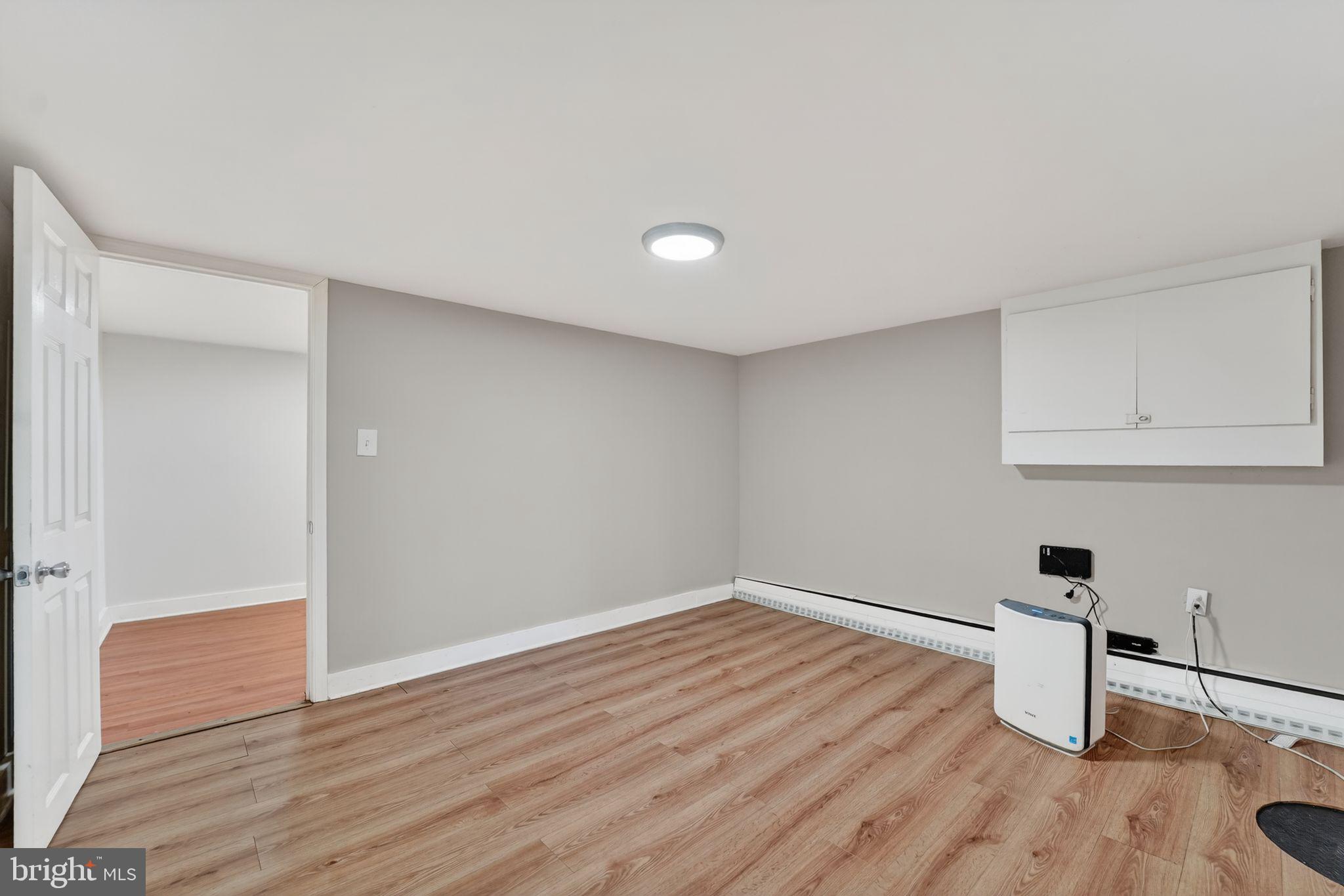 9337 Millbrook Road Ellicott City, MD 21042 - Photo 26 of 33 a room with wooden floor and white walls