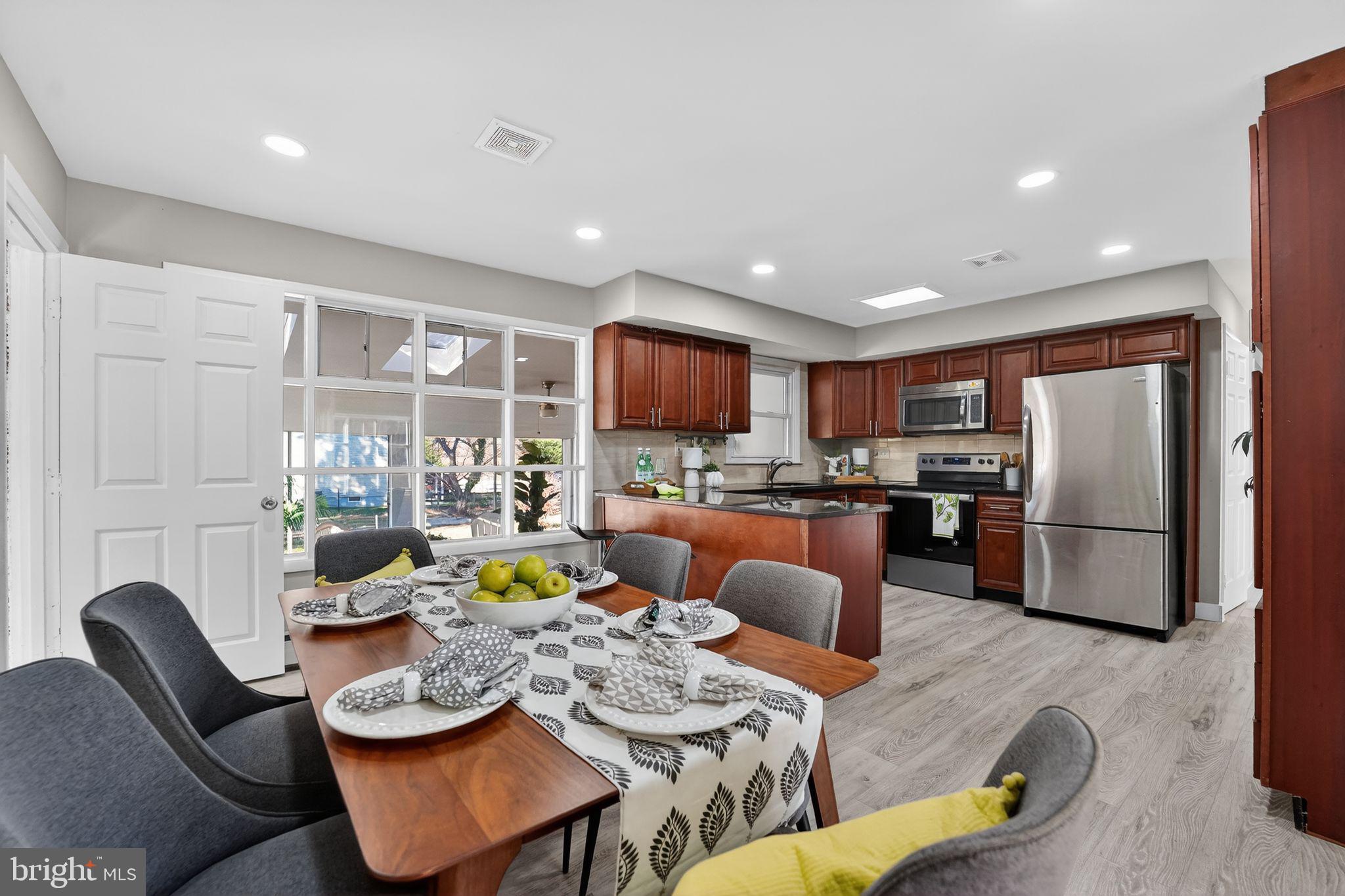 9337 Millbrook Road Ellicott City, MD 21042 - Photo 3 of 33 a living room with furniture kitchen view and a refrigerator