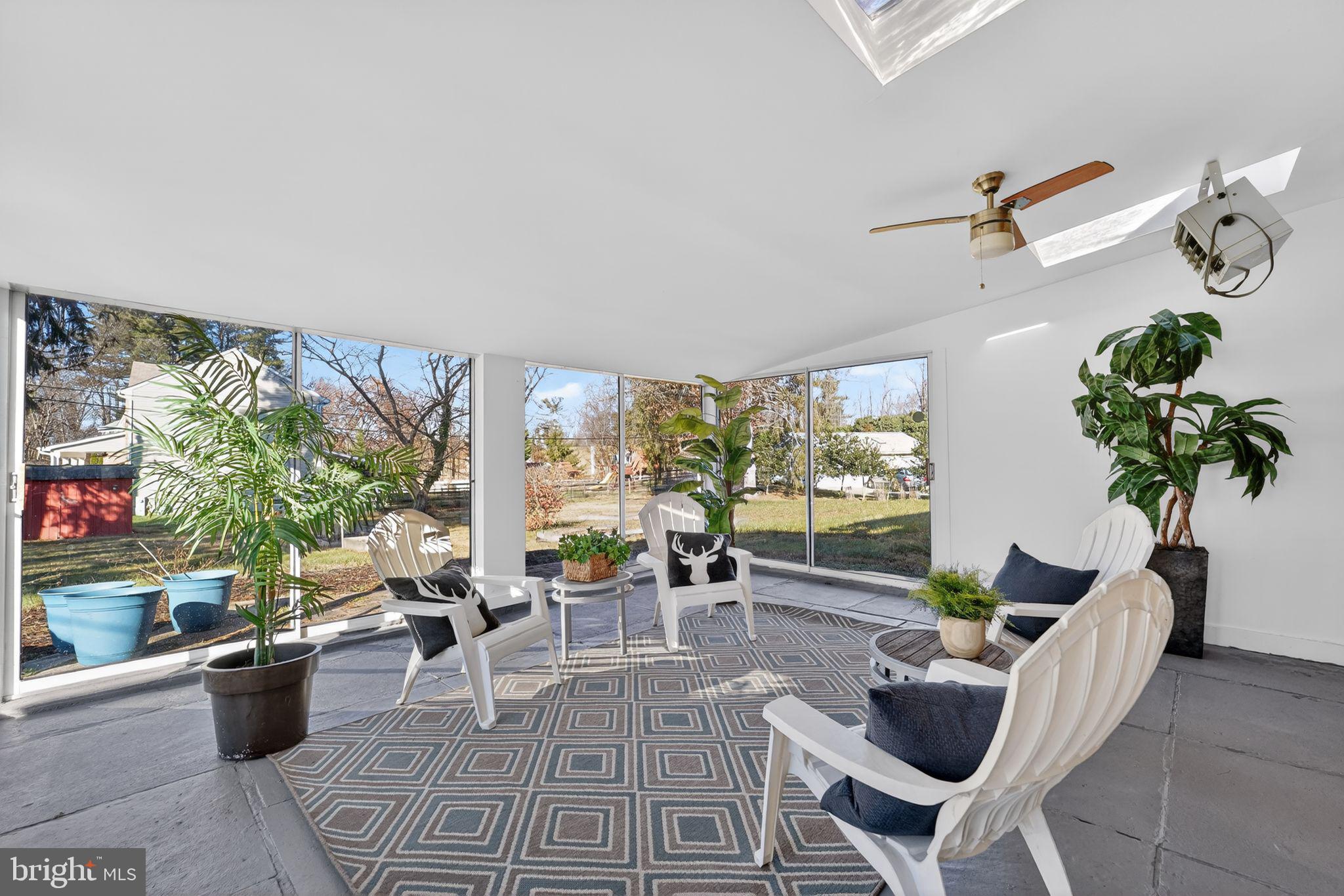 9337 Millbrook Road Ellicott City, MD 21042 - Photo 6 of 33 a living room with furniture a lamp and a potted plant