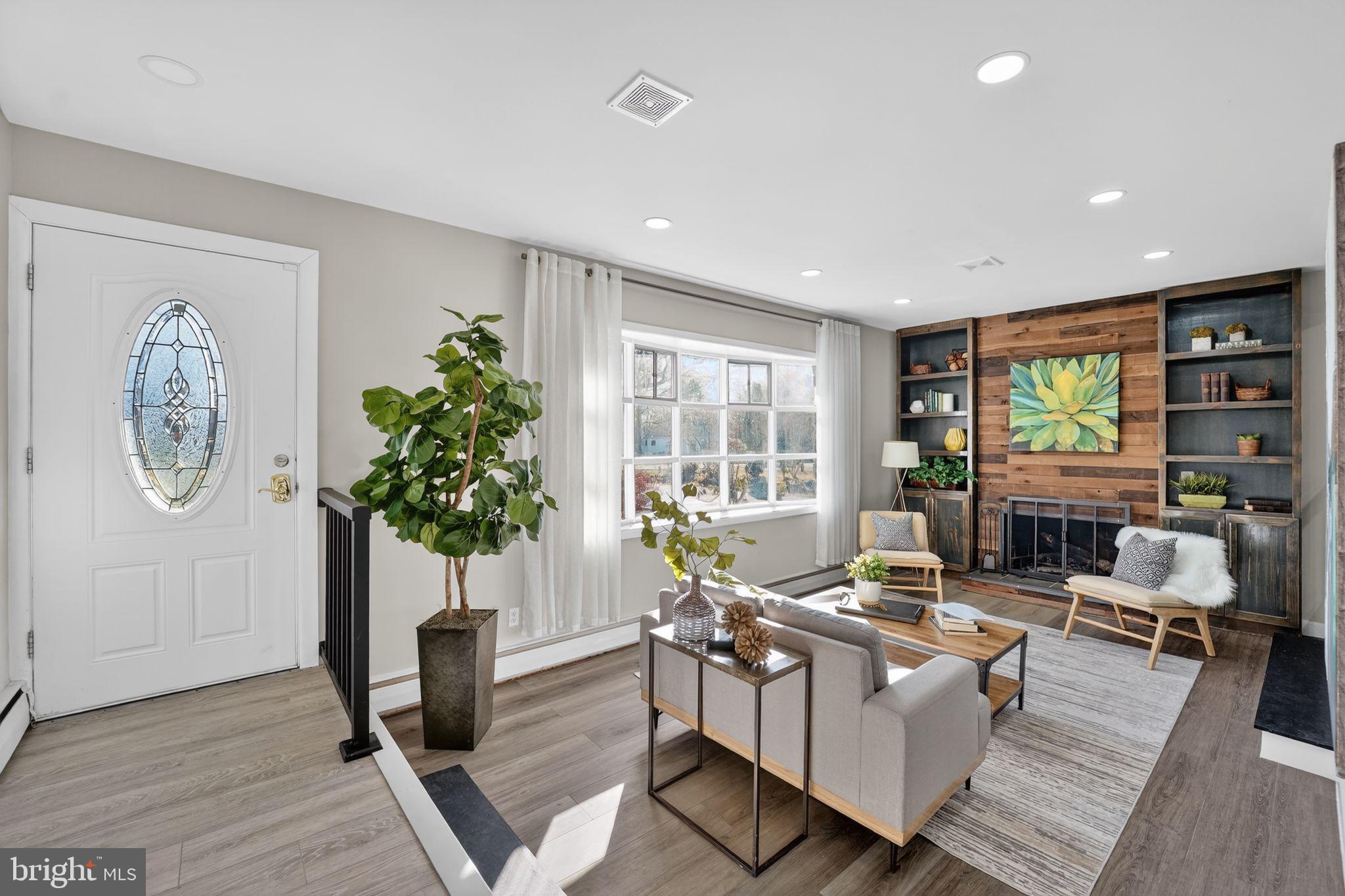 9337 Millbrook Road Ellicott City, MD 21042 - Photo 9 of 33 a living room with furniture a window and a potted plant