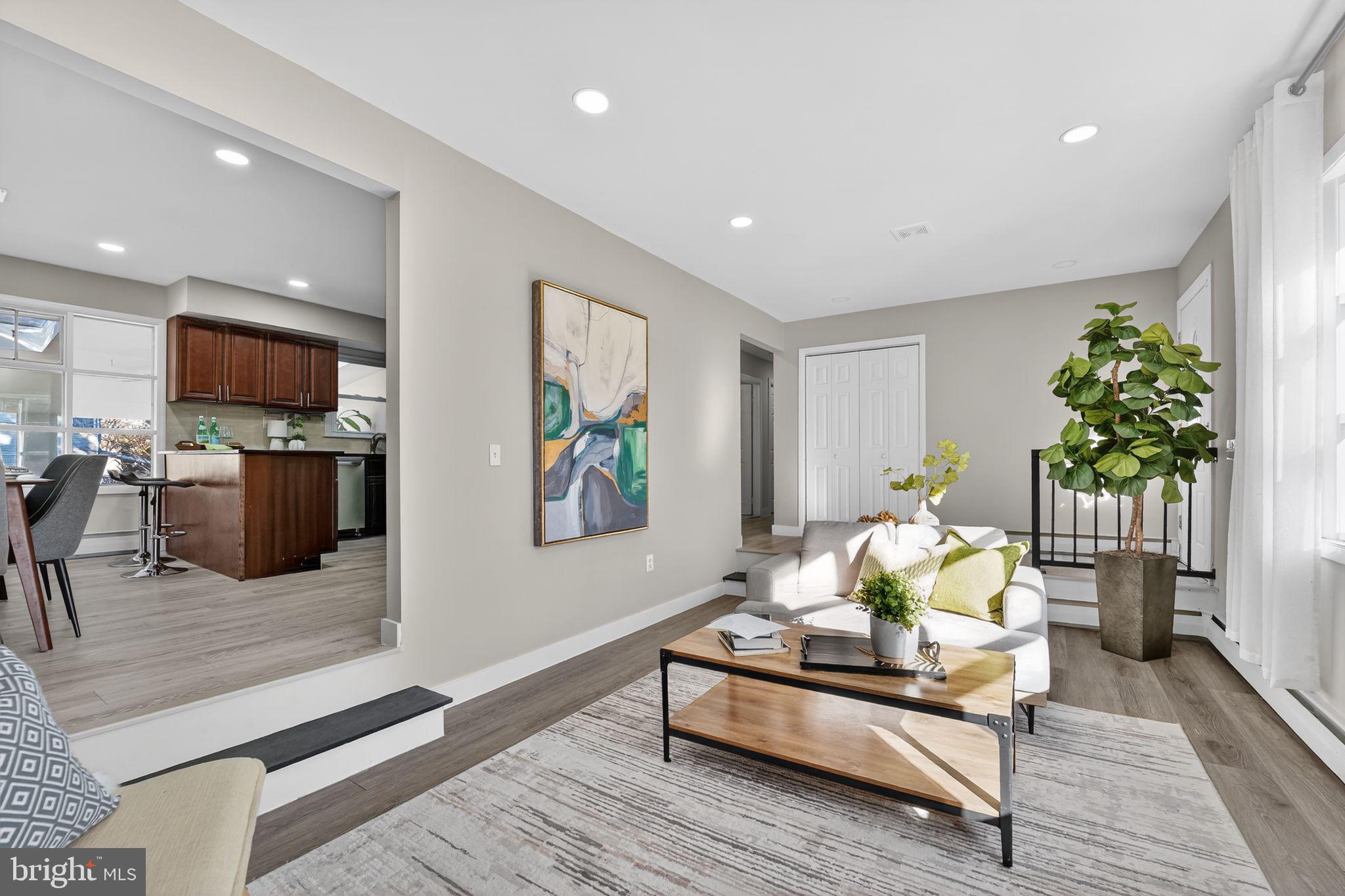 9337 Millbrook Road Ellicott City, MD 21042 - Photo 10 of 33 a living room with furniture and a flat screen tv