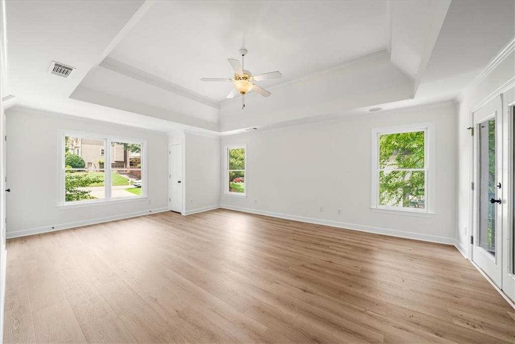 1710 Rising Mist Lane Cumming, GA 30041 - Photo 38 of 111 an empty room with window ceiling fan and wooden floor