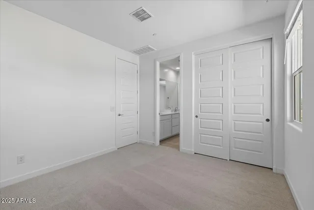 an empty room with closet area