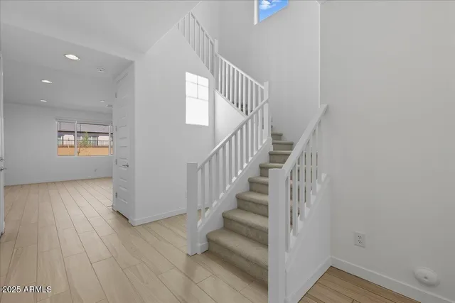 a view of entryway with wooden floor and stairs