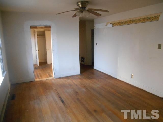 432 Peyton Street Raleigh, NC 27610 - Photo 3 of 12 a view of a hallway with wooden floor and a chandelier fan