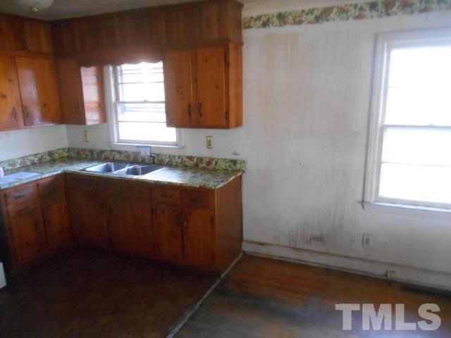 432 Peyton Street Raleigh, NC 27610 - Photo 6 of 12 a kitchen with granite countertop cabinets sink and window