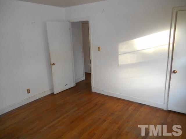432 Peyton Street Raleigh, NC 27610 - Photo 10 of 12 a view of an empty room with wooden floor