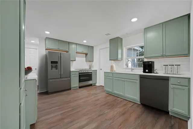 a kitchen with a refrigerator and a sink