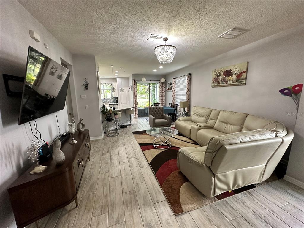 250 Rustic Loop Sanford, FL 32771 - Photo 2 of 33 a living room with furniture and a flat screen tv