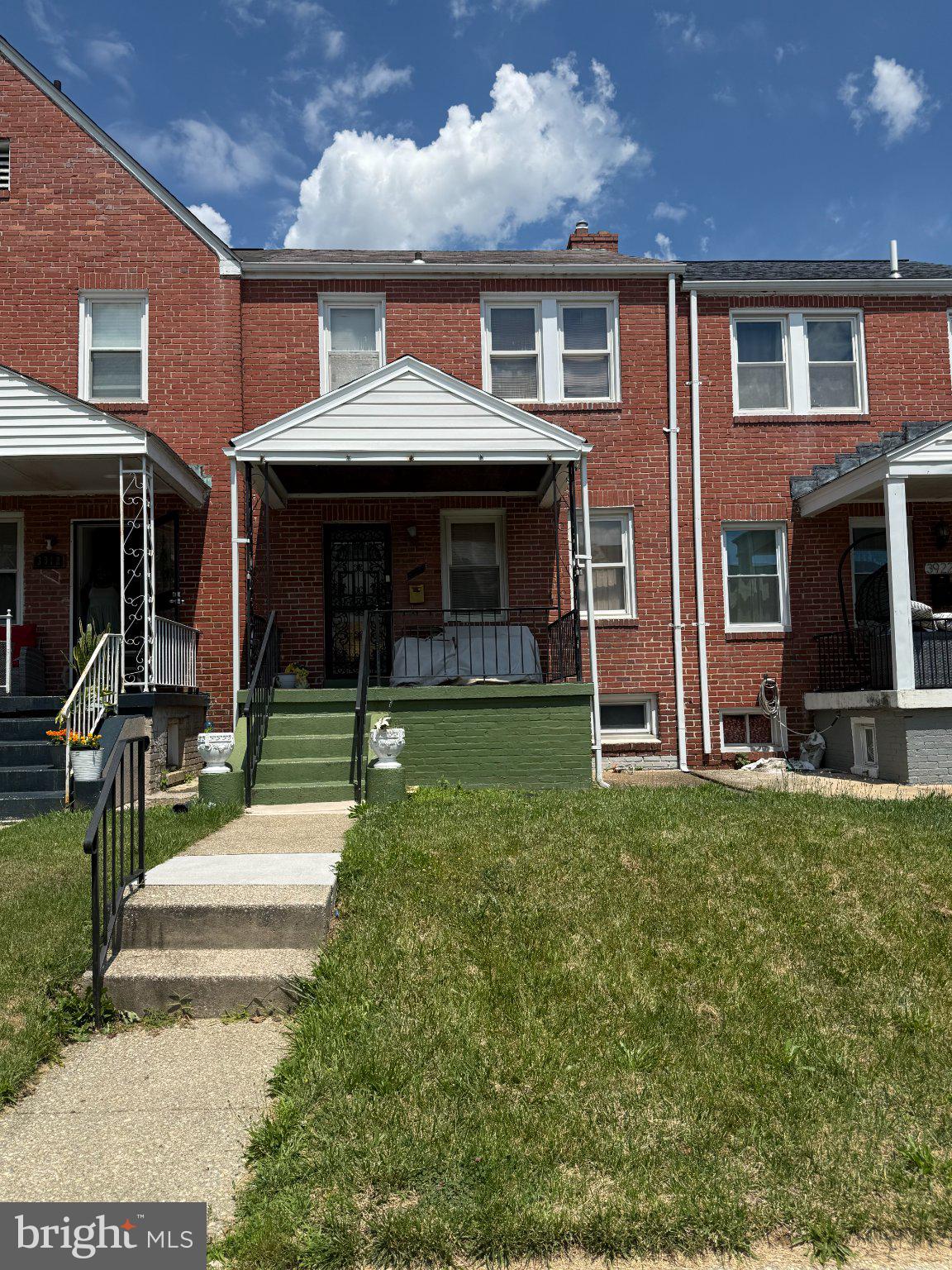 Charming brick home with inviting porch.