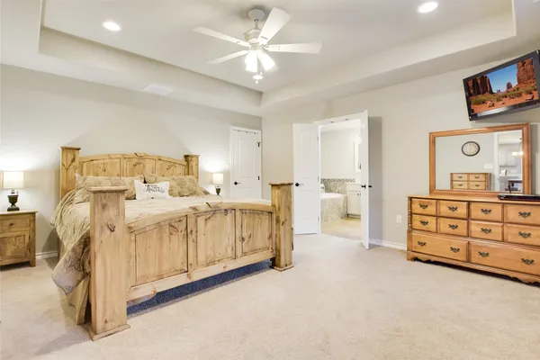 a spacious bedroom with a large bed and a large window