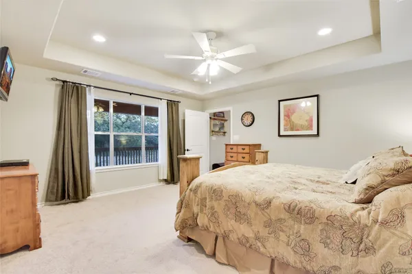 a bathroom with a granite countertop sink mirror and bathtub