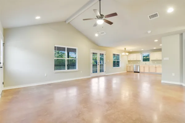 a open kitchen with white cabinets and a refrigerator