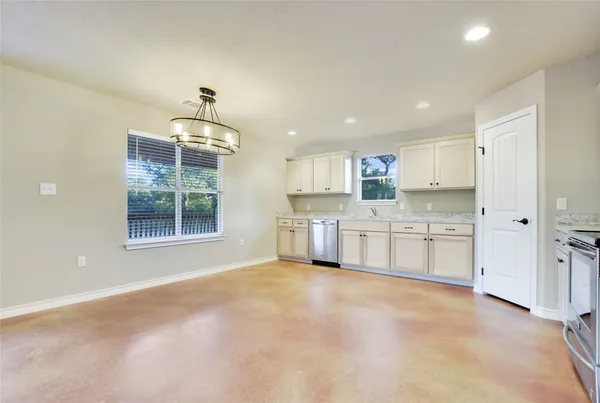 a large kitchen with cabinets and stainless steel appliances