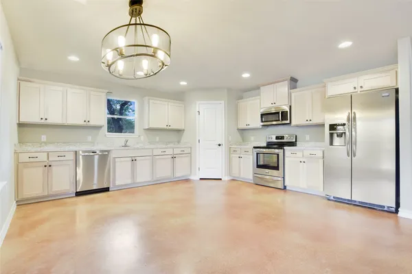 an empty room with a bathroom and a shower