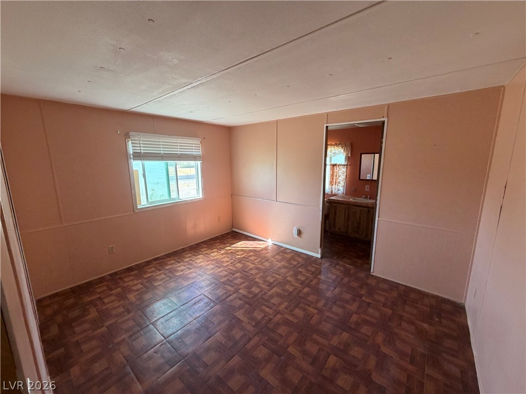 4360 Retread Road Pahrump, NV 89048 - Photo 10 of 19 Patterned vinyl flooring and wood-paneled walls define this functional living space.