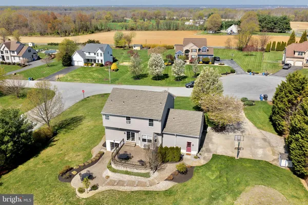 an aerial view of a house with garden space and ocean view