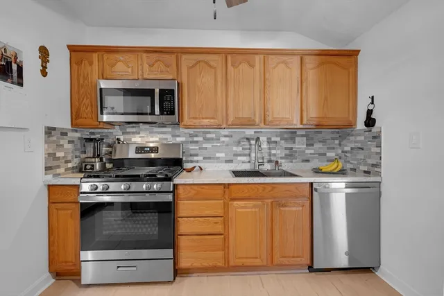 a kitchen with stainless steel appliances granite countertop a stove and a microwave