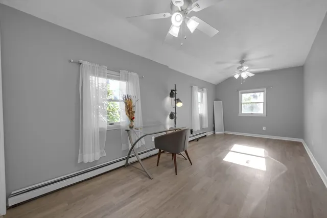 a view of a livingroom with furniture window and wooden floor