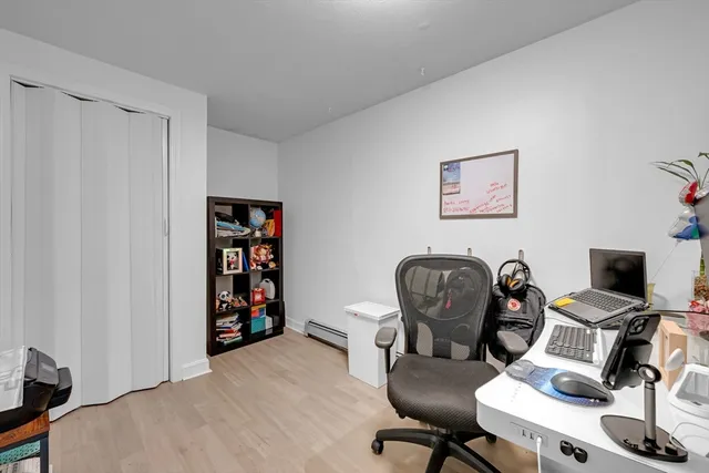 a view of a workspace with furniture and a window