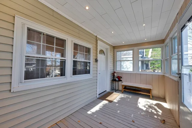 a view of a room with wooden floor and windows