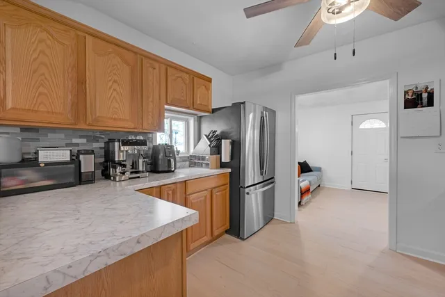 a kitchen with stainless steel appliances granite countertop a refrigerator a stove and a sink with cabinets