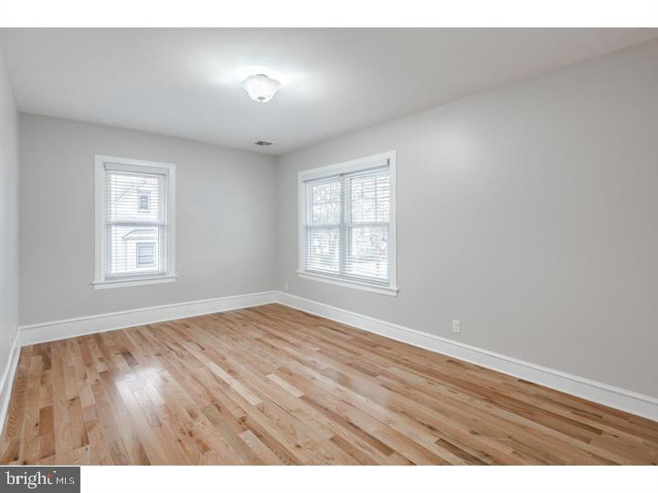 309-311 Warwick Road Haddonfield, NJ 08033 - Photo 10 of 12 an empty room with wooden floor and windows