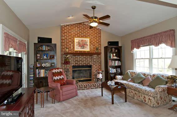 3721 Ligon Road Ellicott City, MD 21042 - Photo 2 of 30 a living room with furniture a flat screen tv and a fireplace