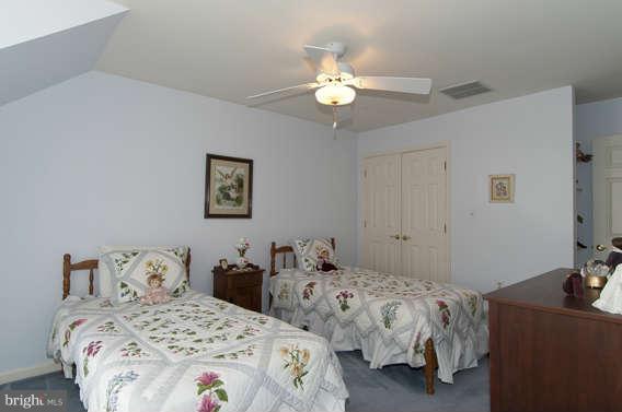 3721 Ligon Road Ellicott City, MD 21042 - Photo 12 of 30 a bedroom with two beds and a chandelier